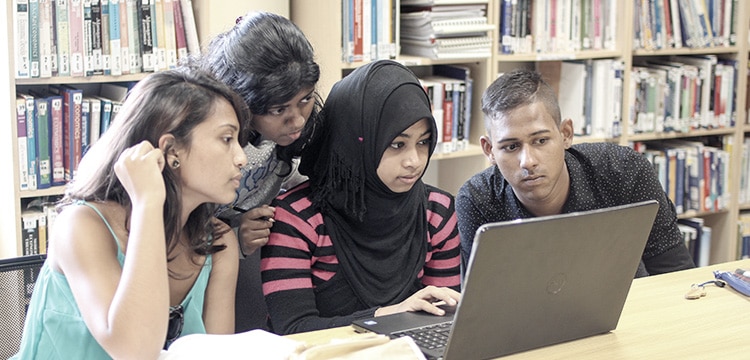 Students interacting in the library Students interacting in the library